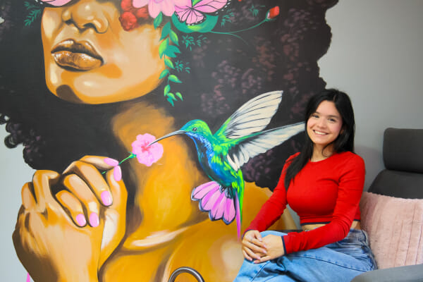 Client displaying finished nail art at a Costa Rica esthetics salon, natural expression