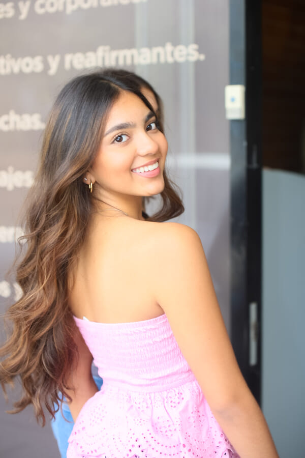 Vertical model showcase portrait at a Costa Rica esthetics salon, clean studio backdrop