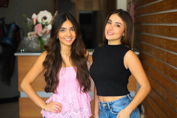 Model showcase at a Costa Rica esthetics salon, branded environment behind the model