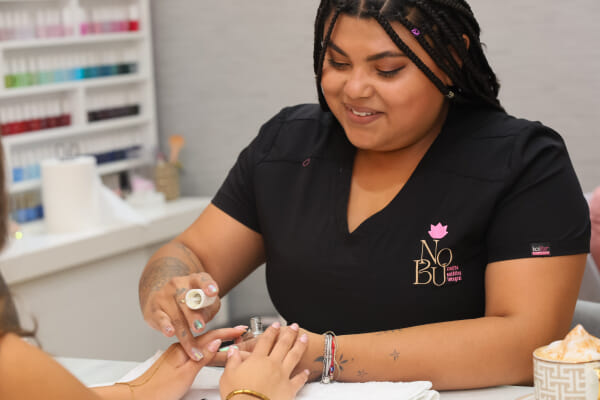 Staff applying skincare product at a Costa Rica esthetics salon, hands-on treatment in progress