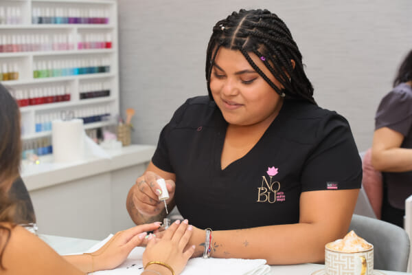 Salon staff applying skincare product at a Costa Rica esthetics studio, treatment in progress